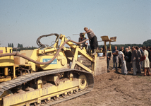 824512 Afbeelding van wethouder C. Pot op de draineermachine tijdens de start van de aanleg van het sportpark Strijland ...